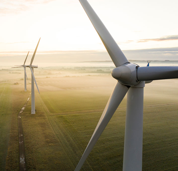 three wind turbines in a field